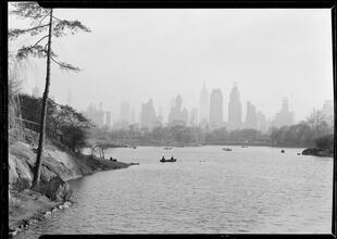 New York City views. Central Park, 59th Street buildings over lake.