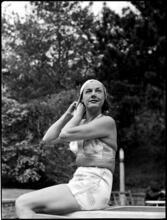 Billy Rose [Eleanor Holm putting on a swimming cap.]