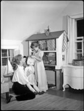 Fashion Models: Lisa Fonssagrives [Lisa Fonssagrives playing with her daughter at home.]