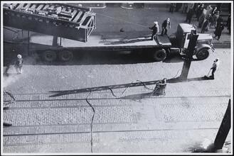 [Placing truss on trailer.]
