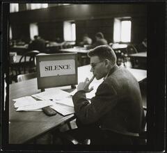 Columbia University [Student studying in Butler Library.]