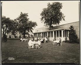 [Hawthorne Court. Apartment buildings and tea room with people dining outdoors.]