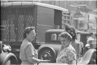 Street Conversations [Three women talking on the street.]