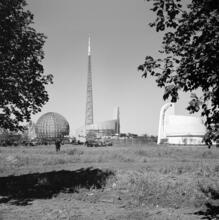 [Construction of the New York World's Fair site, with the steel frames of the Trylon and Perisphere in the background.]