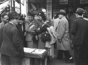 Untitled [Women shopping at street vendor in front of hot dog stand, Union Square]