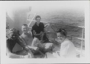 [Male and female crew members on deck of ship.]