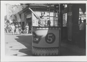 [Man selling tickets on Coney Island midway.]