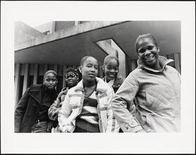 Girls posing in front of the Junior High School on Third Avenue