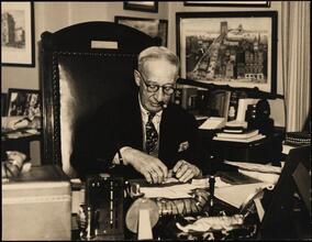 [Al Smith at his desk.]