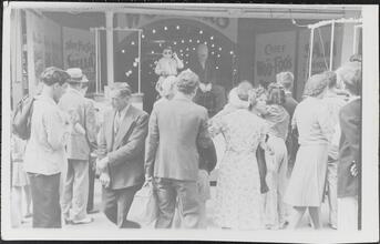 [Crowd gathered in front of sideshow at Coney Island.]