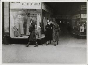 [Women looking at window display.]