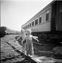 Circus [Boys playing on train tracks.]