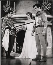 [Roddy McDowall as Mordred, Julie Andrews as Guenevere, and Robert Goulet as Lancelot Du Lac in Act 2, Scene 6 of "Camelot".]