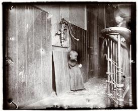 Baby in slum tenement, dark stairs--it's playground.