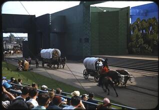 [Actors in Conestoga wagons during the Parade of Railroads show.]