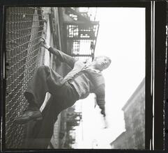 Shoe Shine Boy [Mickey climbing a fence.]