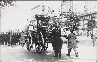 [Firemen pulling equipment.]