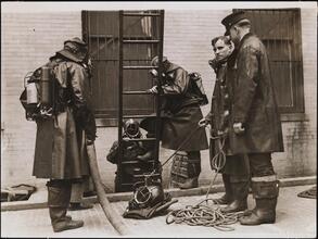 [Firemen in smoke helmets.]
