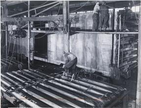 [Men assembling boxcars.]
