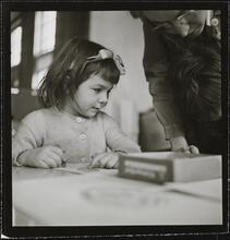 Orphanage [Woman looking at a girl's drawing.]