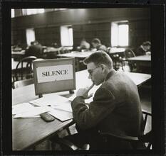 Columbia University [Student studying in Butler Library.]