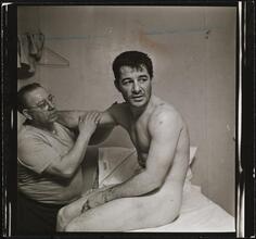 Rocky Graziano, He's a Good Boy Now [Man massaging Rocky Graziano's arm.]