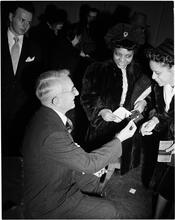 Dale Carnegie [Dale Carnegie talking to two women.]
