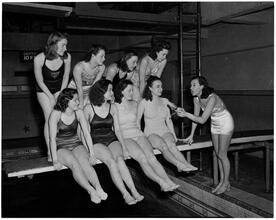 Holm, Eleanor- World's Fair N.Y. Swimming Pool [Eleanor Holm's students seated on diving board.]