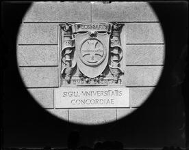 University Club seal on building wall.