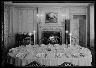 Carroll Carstairs [residence]. Dining room table set with candles lighted (dark effect).