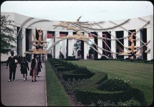 [People by the "Time" sculpture in front of the Business Systems and Insurance Building.]
