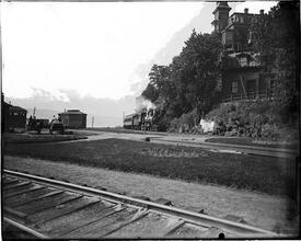 Spuyten Duyvil [steam locomotive passing a large house at a railroad junction]