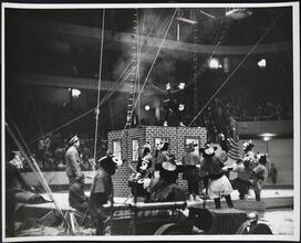 [Clowns dressed in mice costumes at a circus.]