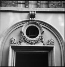 [Architectural ornamentation above doorway.]