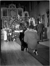 [Women kneeling at an altar.]
