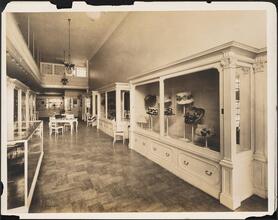 [Interior, clothing store. Hat display.]