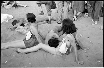 [Teenagers relaxing on Coney Island beach.]