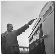Paddy Wagon [Actor holding a gun on the set of the television show Paddy Wagon.]