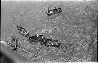 [Men in rowboats.]