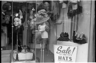[Hat displays in store window.]