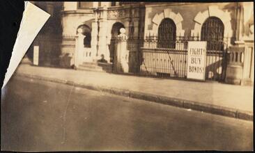 Street Scenes, etc. Showing Displays of Liberty Loan Posters during World War I [Liberty Loan banner on a fence at Riverside Drive and 77th Street.]