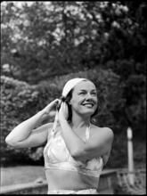Billy Rose [Eleanor Holm putting on a swimming cap.]