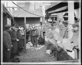 East 110th Street at the Harlem River. Distributing coke [coal] to the poor people.