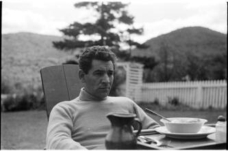 Leonard Bernstein [Leonard Bernstein sitting at an outside table.]