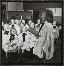 Orphanage [Girl singing in front of a choir.]