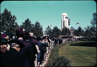 [People in line with the Goodrich Building in the distance.]