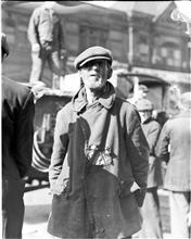Waterfront. [Man in a tattered coat.]