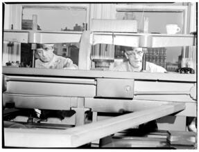 [Men working at machine.]
