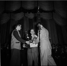 Swing Band Contest Sponsored by LOOK [Boy receiving a trophy.]