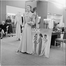 Lord & Taylor Display [A mannequin dressed in a housecoat in front of a LOOK magazine poster.]